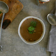 Load image into Gallery viewer, 100% grass-fed and field harvested buffalo bone broth in a white bowl on a white background