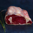 Load image into Gallery viewer, 100% grass-fed and field harvested raw bison prime rib roast on a black background
