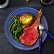 Load image into Gallery viewer, 100% grass-fed and field harvested bison prime rib roast plated with green beans and a baked potato