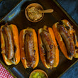 Load image into Gallery viewer, 100% grass-fed and field harvested bison bratwurst in buns on a tray with mustard