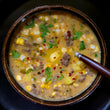Load image into Gallery viewer, 100% grass fed and field harvested buffalo chorizo corn chowder in an earthware bowl