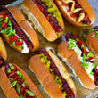 Load image into Gallery viewer, 100% grass-fed and field harvested bison hot dogs grilled and placed into buns