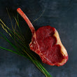 Load image into Gallery viewer, 100% grass-fed and field harvested raw bison bone-in ribeye steak
