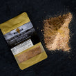 Load image into Gallery viewer, Overhead shot of jamaican jerk seasoning packet next to a loose pile of jamaican jerk seasoning