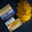Load image into Gallery viewer, overhead shot of curry seasoning packet atop a pile of loose curry powder