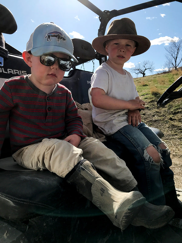 Lincoln and barrett sitting in an ATV