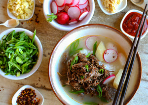 Bison Ox-Bone Soup in Bowl with shredded Bison meat and condiments