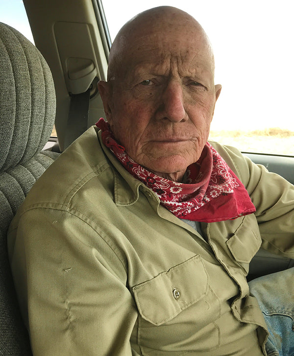 Dan sitting in a truck wearing a red bandana