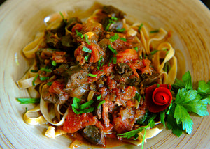 Bison Heart stewed with tomatoes on pasta