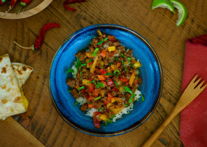 Bison meat stir fry with peppers over rice