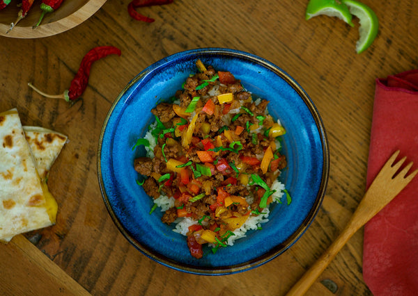 Bison meat stir fry with peppers over rice