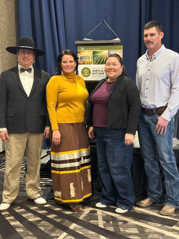 colton jones standing with a group of people at a conference