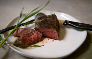 100% grass-fed buffalo steak on a white plate