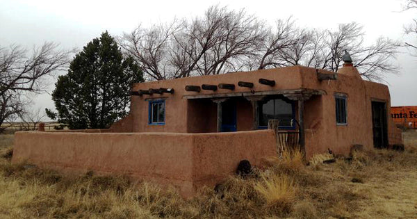 tiny adobe cabin nestled in the sand dunes of far eastern New Mexico