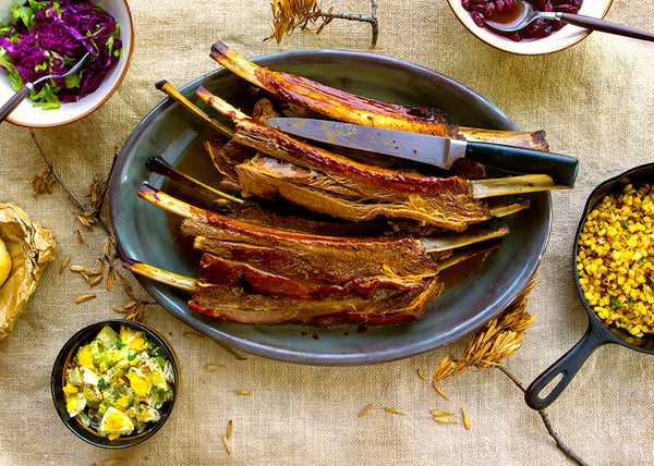 Whole BBQ Bison Short Ribs cooked on sliced between the bone on a platter
