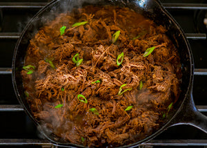 Bison Chuck Roast, braised and pulled in a black skillet