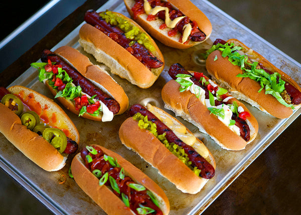 Bison Hot Dogs grilled in buns with various toppings