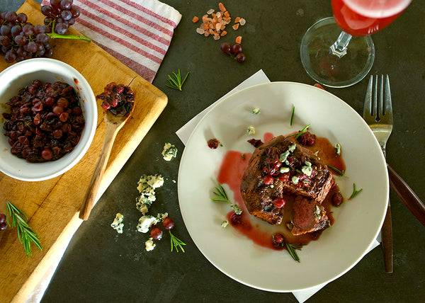 Grilled bison steaks with grape sauce and blue cheese