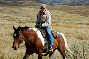Dan atop a brown and white horse 