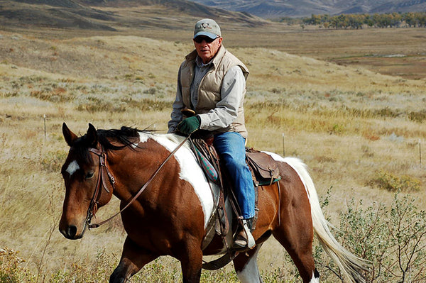 Dan atop a brown and white horse 