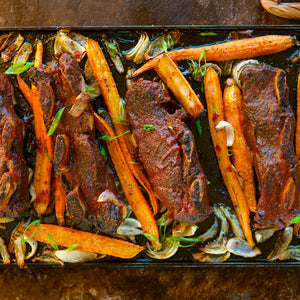 100% grass-fed and field harvested spiced bison short ribs on a sheet tray