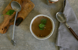 100% grass-fed and field harvested buffalo bone broth in a white bowl on a white background
