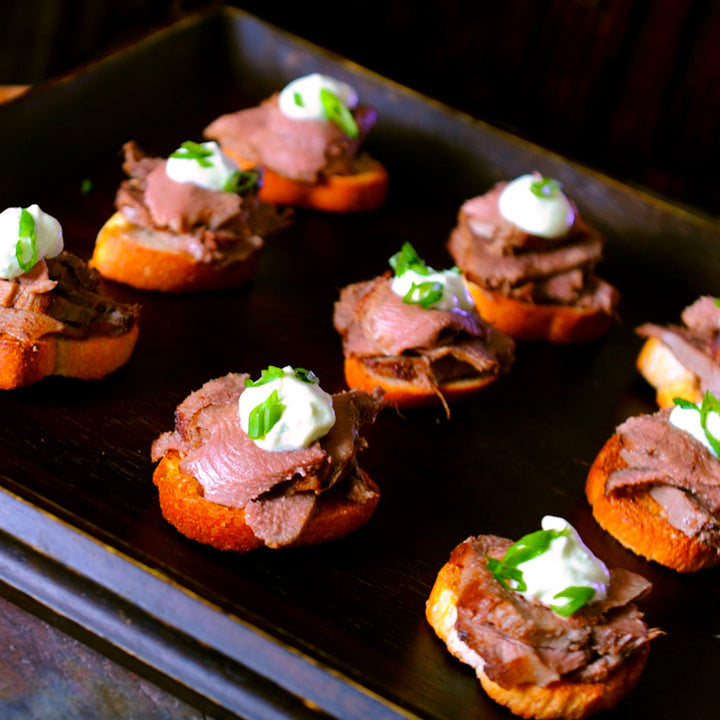 100% grass-fed and field harvested braised buffalo tongue canapes on crositini