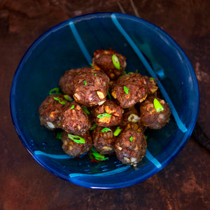 100% grass-fed buffalo liver and ground meatballs in a blue bowl with chives