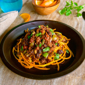 100% grass-fed and field harvested ground buffalo picadillo on a black plate