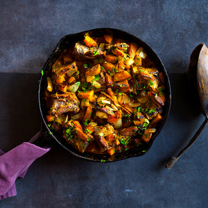 100% grass-fed and field harvested curried bison short ribs in a skillet