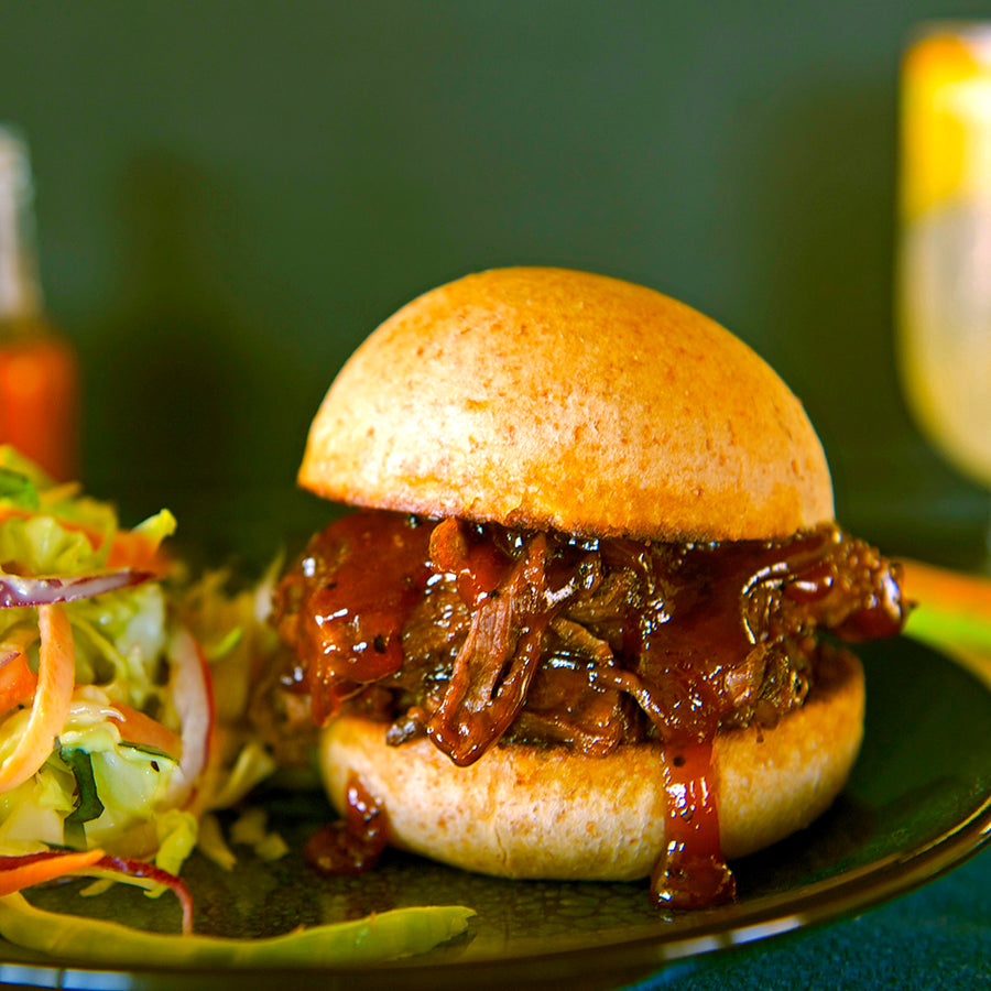 100% grass fed and field harvested pulled buffalo chuck roast with barbecue sauce on a brioche bun