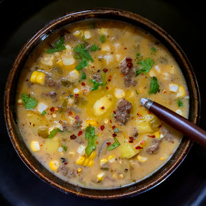 100% grass fed and field harvested buffalo chorizo corn chowder in an earthware bowl