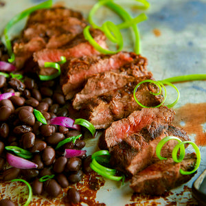 100% grass fed and field harvested grilled buffalo flat iron steak with black beans