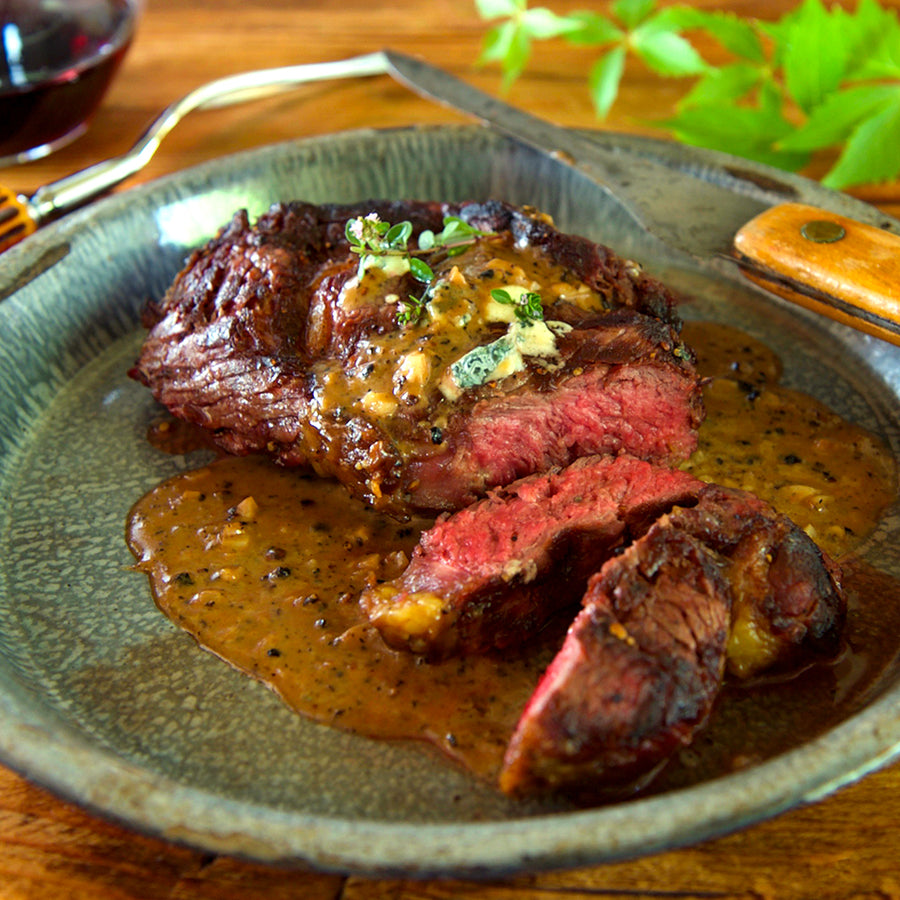 100% grass-fed and field harvested bison ribeye on a blue plate